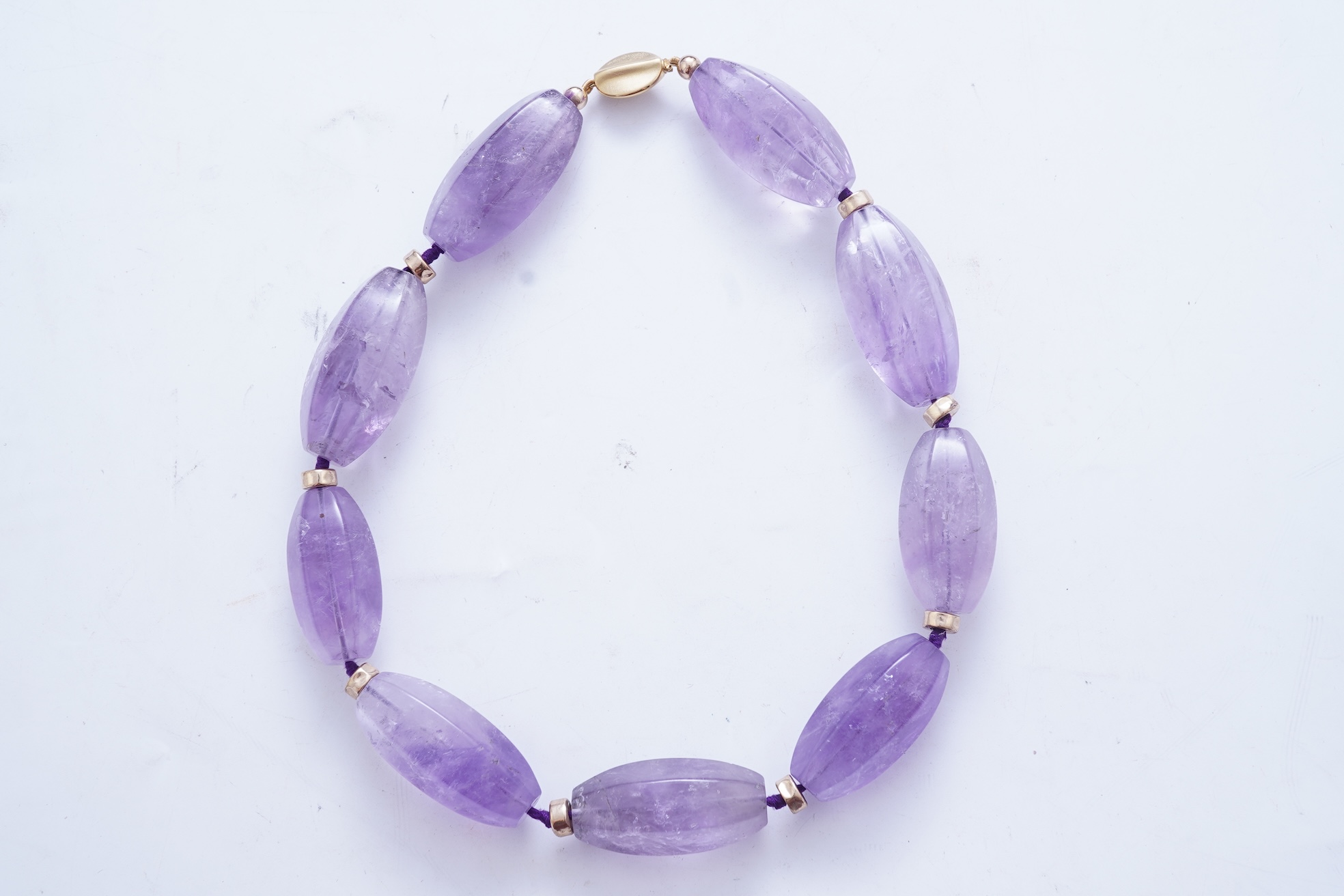 An amethyst and gold necklace
